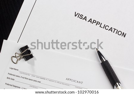 Directly above photograph of an application for a visa.