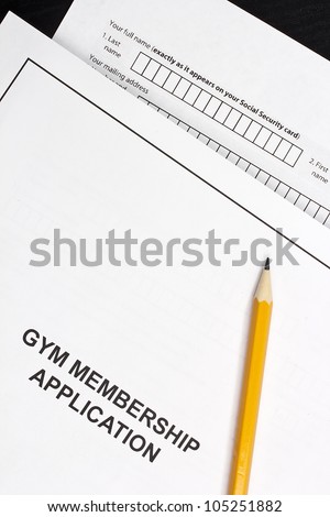 Directly above photograph of a gym application and an orange pencil.