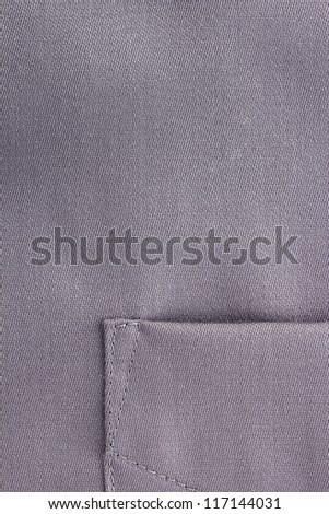 Close-up photograph of a pocket on a silver shirt.