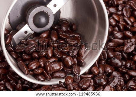 Coffee beans and grind them a tool. Coffee grinder.