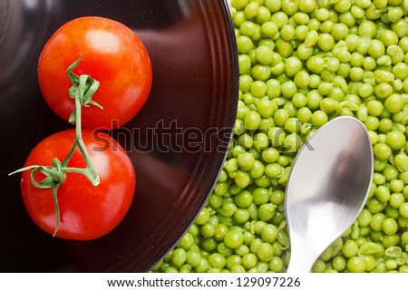 Directly above photograph of red tomatoes and green peas.