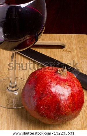 Pomegranate wine in a wine glass. Alcoholic beverage.