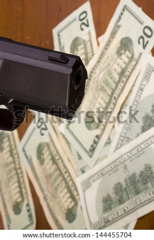 Robbery - gun against the dollar. Industry crime.