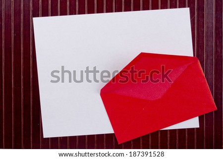 Background with sheet of paper and red envelope