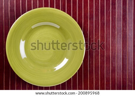Ceramic dish on wooden kitchen litter. Cookware.