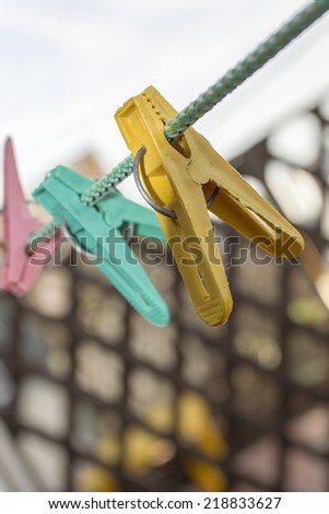 Old plastic clothespins on a clothes line.