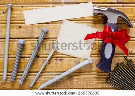 Small hammer with a red bow as a gift for Father\'s day.