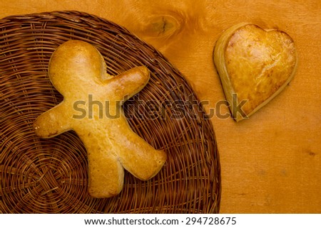 Cookies in the shape of a man and heart cookie.