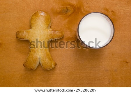 Cookies in the shape of a man and a glass of milk.