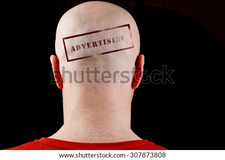 Stamp imprint on his bald head man Advertising.