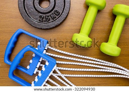 Equipment for sport - dumbbells, stretching expander and a portion of the stacked weights.