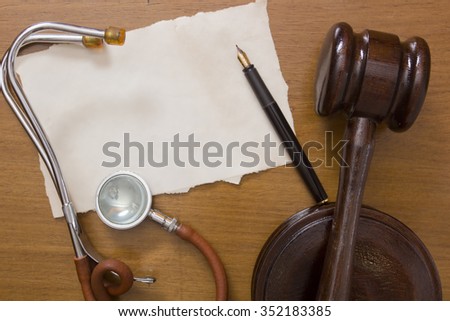 Old Stethoscope and judges hammer, to the subject of law in medicine.