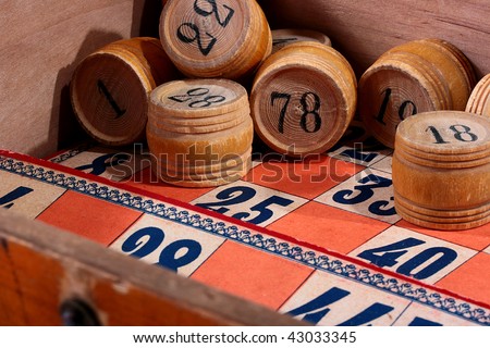 Kegs for game in a lotto, corresponds to game bingo, in a wooden box with cards for this game.