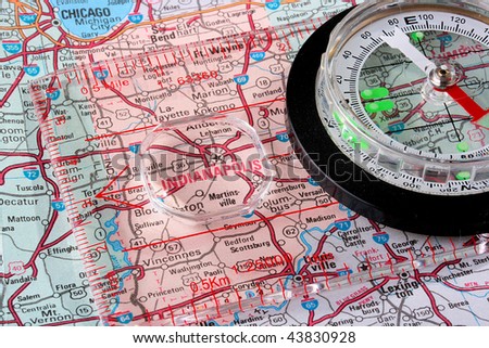USA map with the city of Indianapolis and a compass with magnifying glass over Indianapolis.