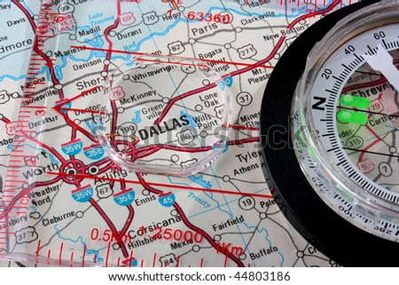 USA map with the city of Dallas and a compass with magnifying glass over Dallas.