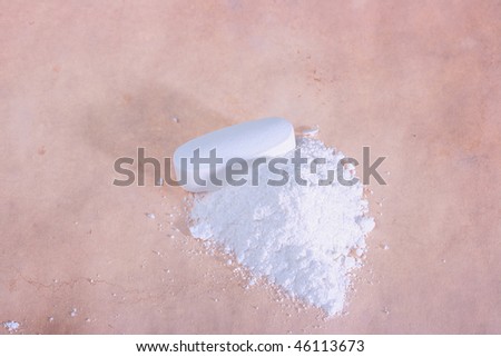 Tablet and the powder received after processing of a tablet in a mortar against from an ancient paper.
