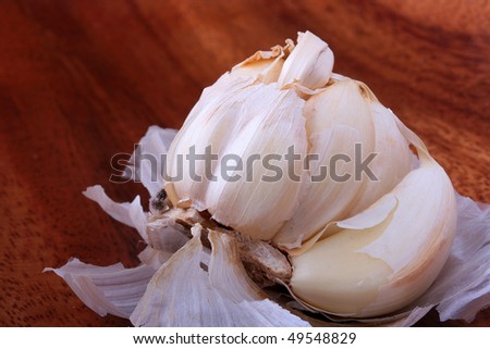 Garlic on a wood background - a menu component in many countries of the world.