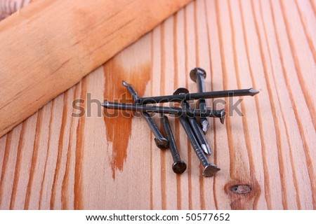 Nails for civil work against a wooden board.