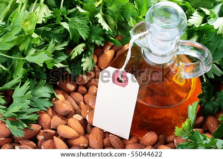 Label on a bottle with vegetable oil from an almond nut with parsley greens.
