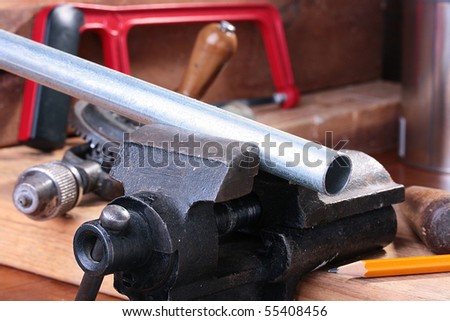 The steel pipe is fixed in a joiner's vice for the further processing.