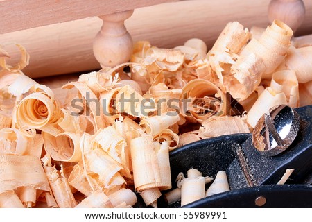 Plane of the small size in a workshop of the carpenter on a workbench among a wood shaving.