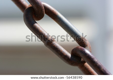 Link of an old rusty chain for restriction of movement or fastening of cargoes.