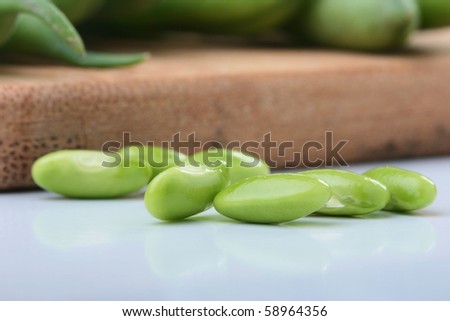 Vegetable kidney bean beans against on a kitchen board.