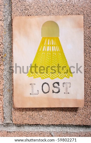 A lost sign with a yellow badminton shuttlecock hanging on a wall.
