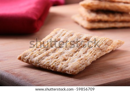 Wheat crackers on a kitchen board - a light meal.