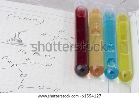 Test tubes laying on a laboratory notebook.