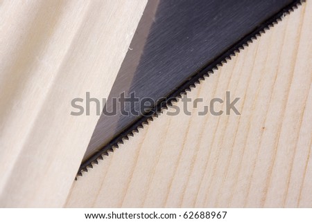 Sharp saw blade on a piece of wood.