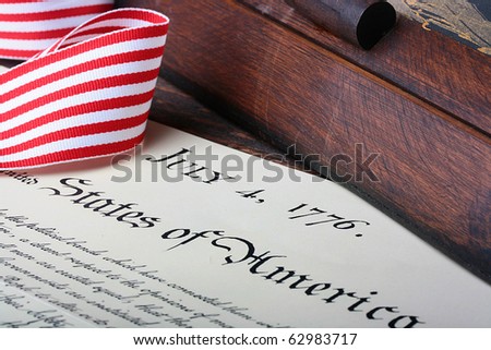 The ancient text of the declaration on independence of the United States of America with a casket and a feather for the write.