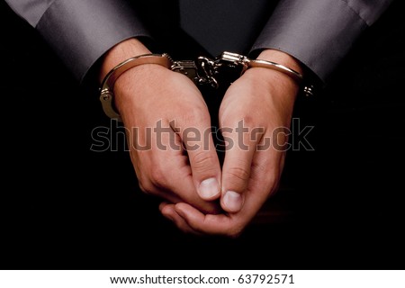 stock photo Closeup of hands handcuffed arrested for questioning