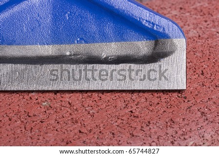 Metal blocking chisel on a red brick.