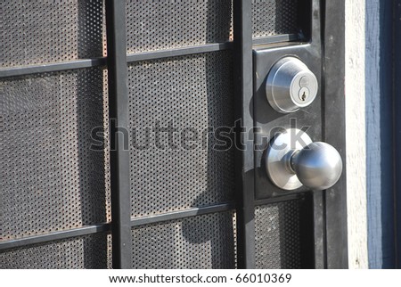 Door lock with a round metal handle on the door.