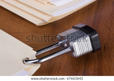 Manila folder closed with a metal lock.