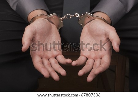 stock photo Closeup of hands handcuffed arrested for questioning