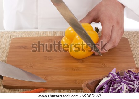 Chef Man cut vegetables on kitchen blackboard.