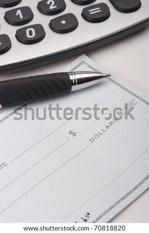 Revealed check book with a pen to fill in check.