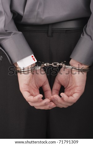 stock photo In the card tricksters hands handcuffed behind his back