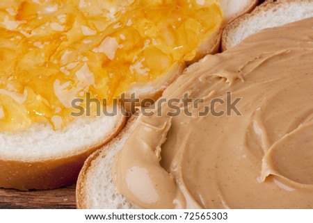 Two pieces of bread with Peanut butter and sweet jam.