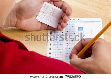Student using a cheat sheet to cheat on his test.