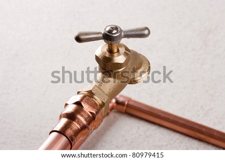 Bronze faucet attached to the water system of copper pipes.