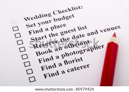 stock photo Red pencil laying on a wedding checklist