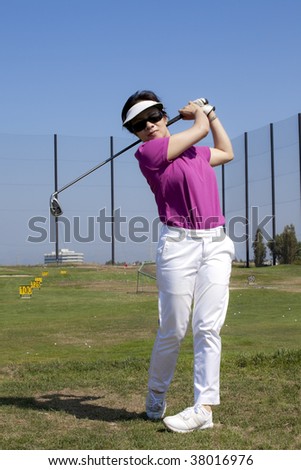 Young Woman Practicing Her Golf Swing