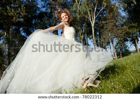 beautiful woman in the field with a wedding dress/woman with wedding dress
