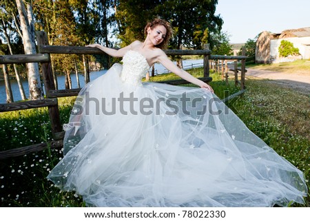 beautiful woman in the field with a wedding dress/woman with wedding dress