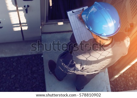 engineer or electrician working on checking status step up transformer high voltage on transformer yard and solution problem to operate at green energy solar power plant