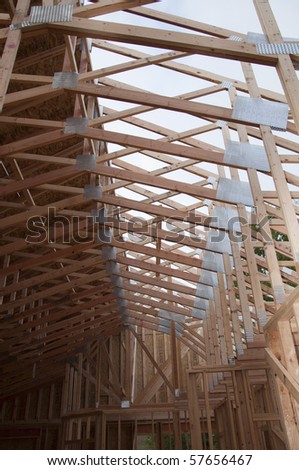 View of unfinished vaulted roof trusses sheeted on one side