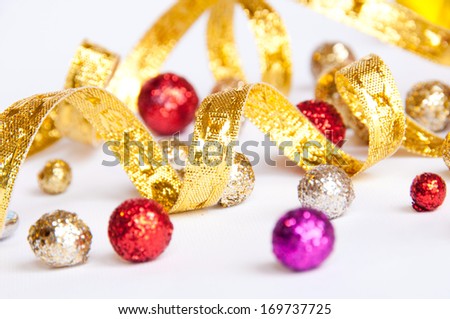 Carnival background with golden curling stream and glittering balls